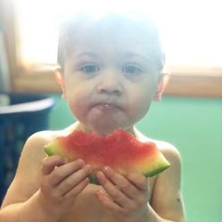 Just a lil baby and his watermelon! Candid portrait of a little boy eating watermelon on a sunny day.