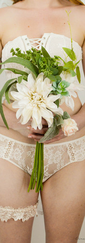 Bridal Bouquet with greenery, fake flowers, beautiful handmade bouquet, lace bridal boudoir outfit, mid area of the body, off white ton, pale skin and shoulder tattoo,