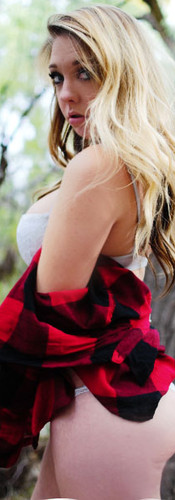 Self love portraits in the middle of the woods in Albuquerque New Mexico in the Bosque, Model embracing her curves, wearing a two piece bikini with a red and black flannel shirt, long blonde wavy hair looking over her shoulder