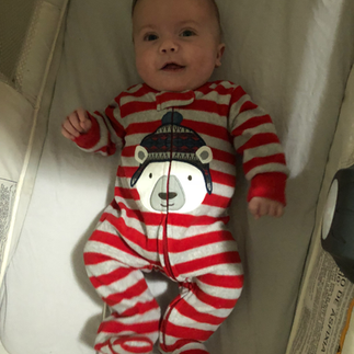 Sweet smiles, cozy vibes, Candid portrait of a baby smiling in a bassinet