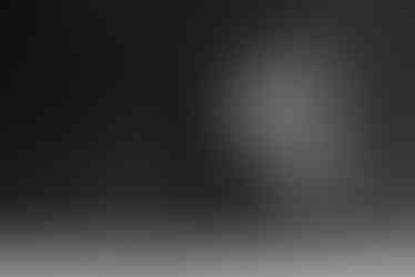 a man and a woman standing next to each other in front of a wall