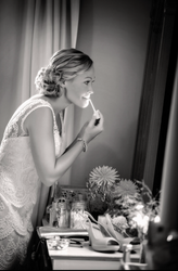 a woman is applying lip gloss in front of a mirror