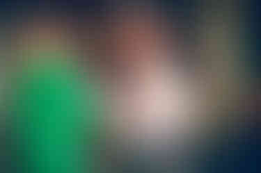 a man and a woman are holding hands and laughing