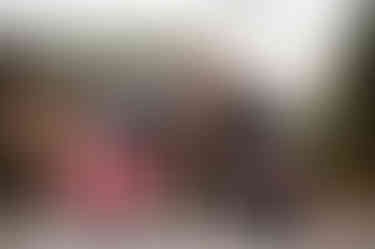 a bride and groom kiss on their motorcycles with a just married sign on the back