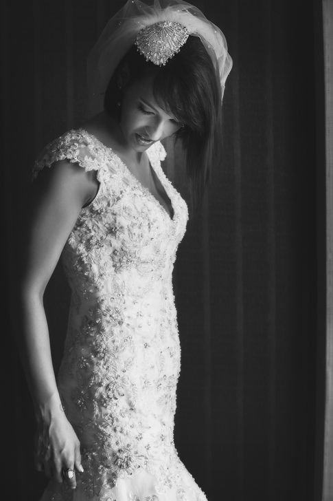 a black and white photo of a woman in a wedding dress