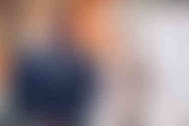 a man in a suit has a flower in his pocket