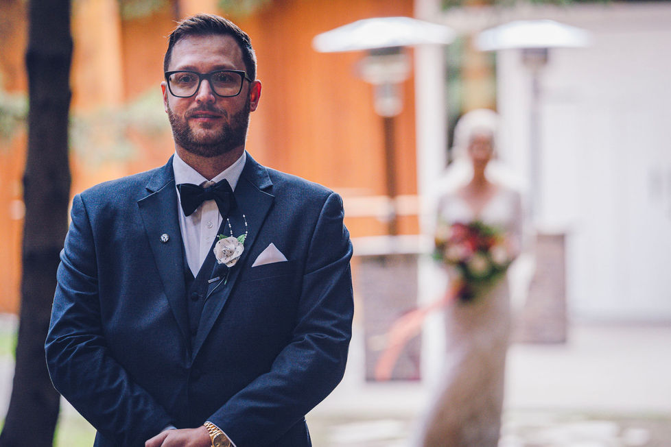 a man in a suit has a flower in his pocket