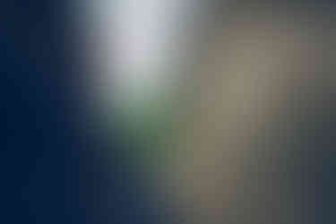 a man and woman are hugging and looking up at the sky