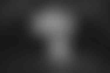 a black and white photo of a bride and groom under a bridge