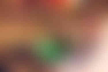 a woman in a green shirt smiles while sitting at a table with a man