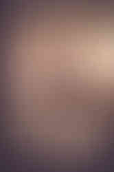 a woman in a white robe sits in front of a window