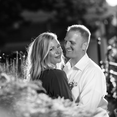 a black and white photo of a man and woman hugging
