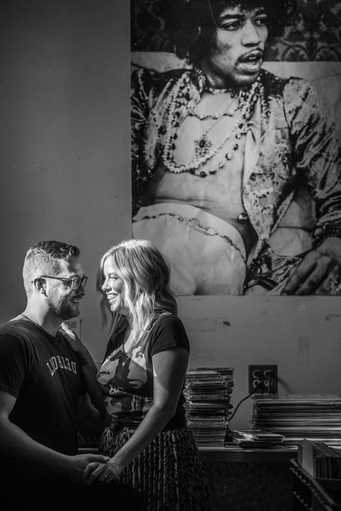 a man wearing a detroit shirt stands next to a woman