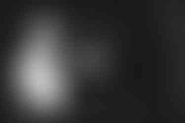 a black and white photo of a bride and groom in a tunnel