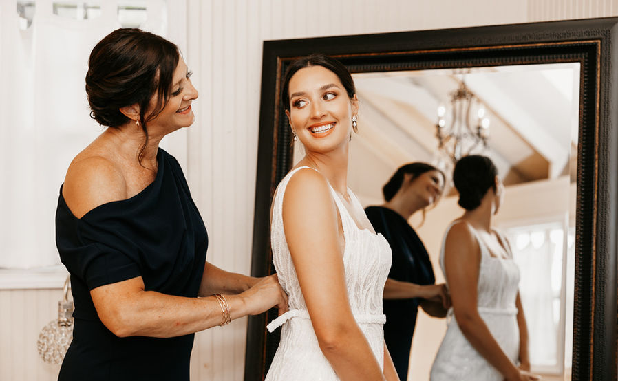 Mother daughter getting ready in bridal suite before wedding 