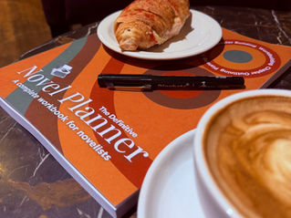 Definitive Novel Planner in a coffee shop