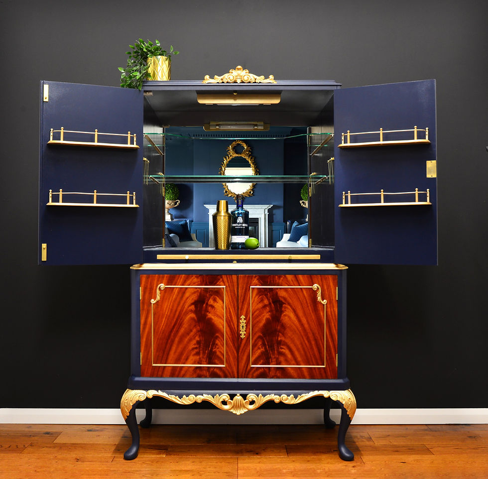 Thumbnail: Mirrored interior of mahogany drinks cabinet in navy blue with glass shelves.