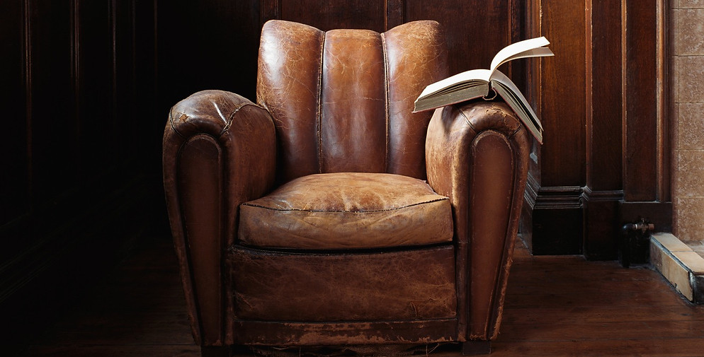 Worn comfortable leather chair where storyteller sit and reads stories