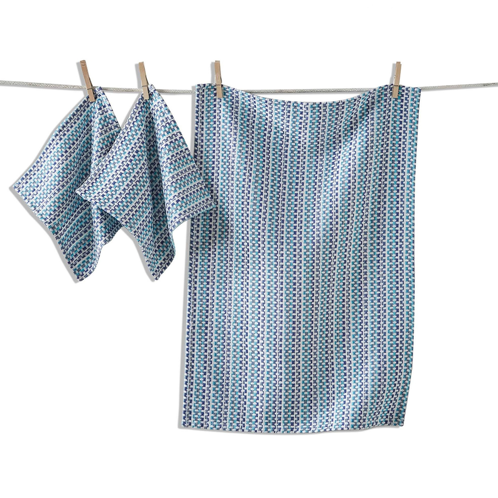A three-piece set of woven tea towels and dishcloths in a blue and white geometric pattern woven tea towels