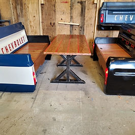 Handcrafted automotive-inspired restaurant booth featuring two pickup-style benches and a matching custom dining table. Built to order and available in the colors and finishes of your choice, this unique set is perfect for restaurants, bars, breweries, game rooms, garages, and man caves.