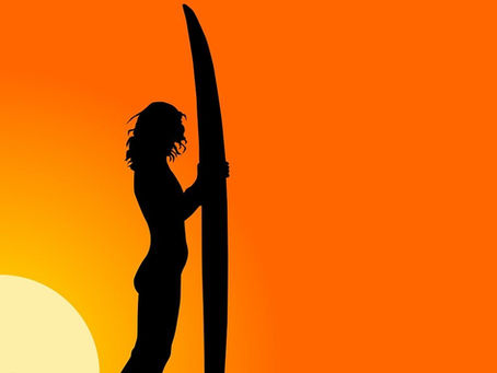 Surfer on a wave with surfboard