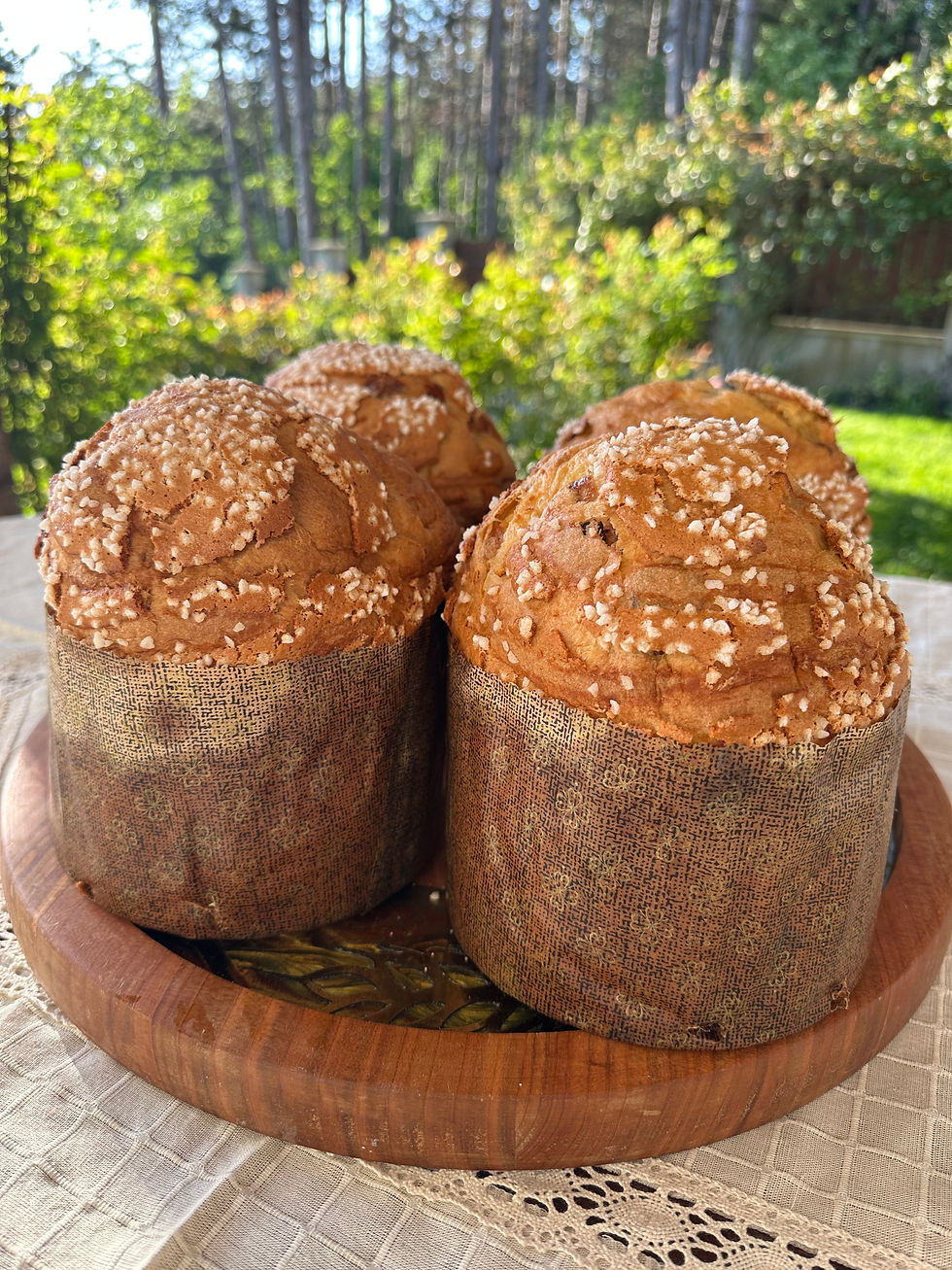 three panettones on a wooden plate