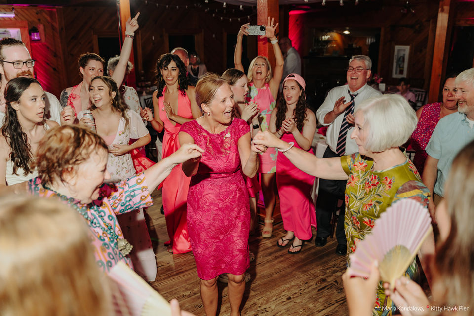 Outer Banks wedding with DJ setup, party lights, and packed dance floor at the Kitty Hawk Pier