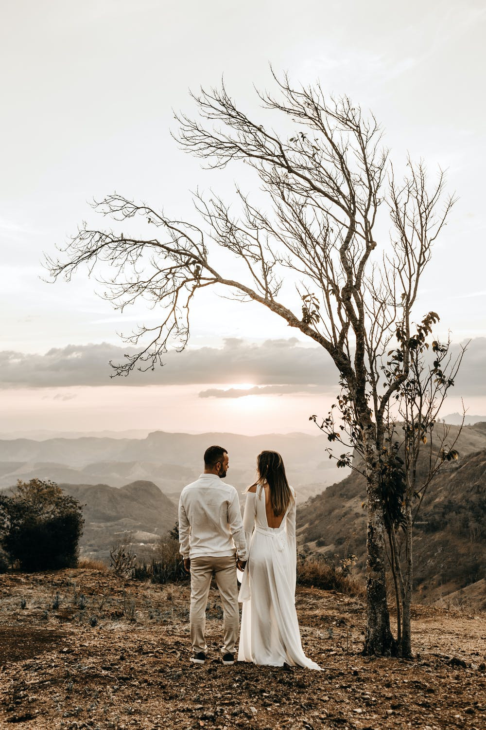 Bride and groom looking out onto autumn countryside