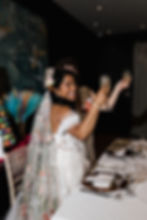 Couple toasting at each other in wedding attire