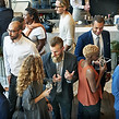 Diverse group socializing, drinking, and celebrating together at a vibrant event.