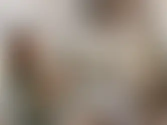 Homeowner checking fresh batteries in a ceiling fan remote while looking at a stationary fan.