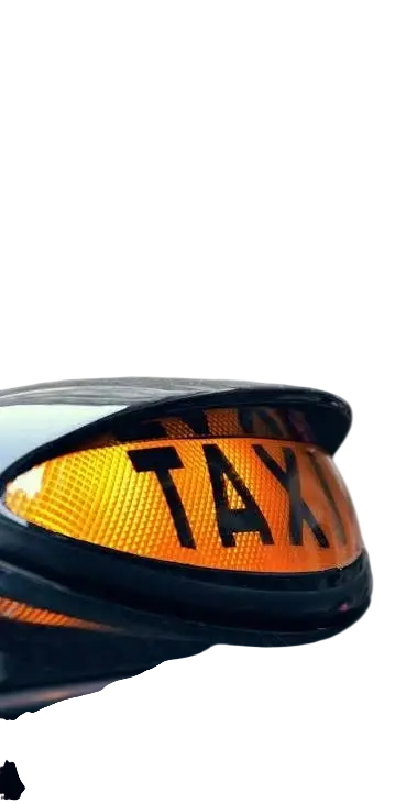 Packshot photography of a bright yellow TAXI sign illuminated against a dark background. It signifies an available ride.