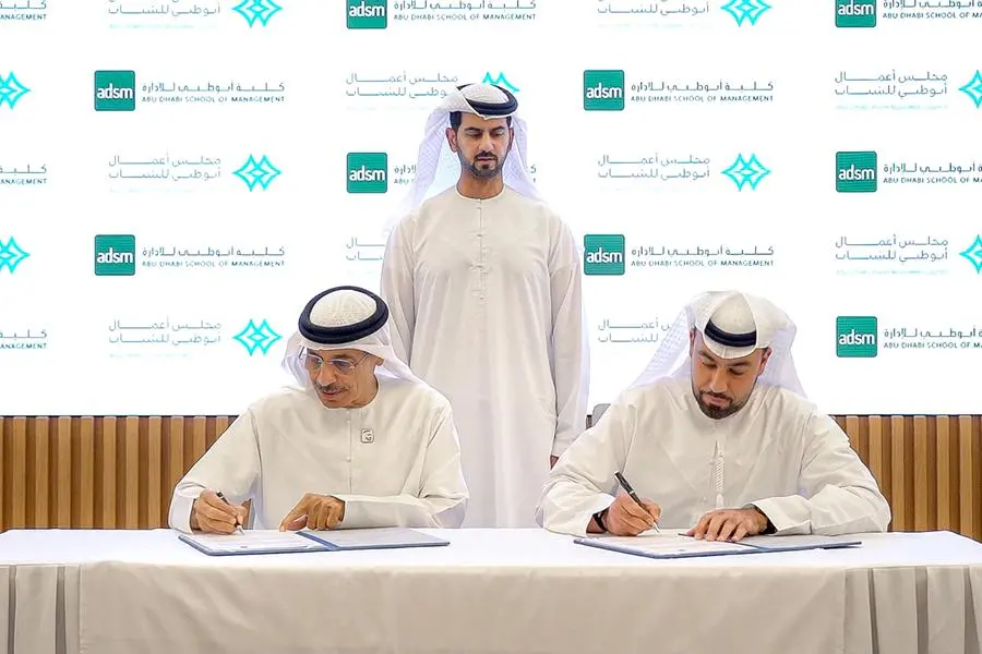 Signing ceremony between the Abu Dhabi Youth Business Council (ADYBC) Chairman and Numou General Manager. Two men in formal attire shake hands over a signing table featuring the ADYBC and Numou logos, symbolizing their strategic partnership to fund youth-led SMEs in the UAE.