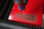 Laser engraving SignBoss Printing logo on red metal