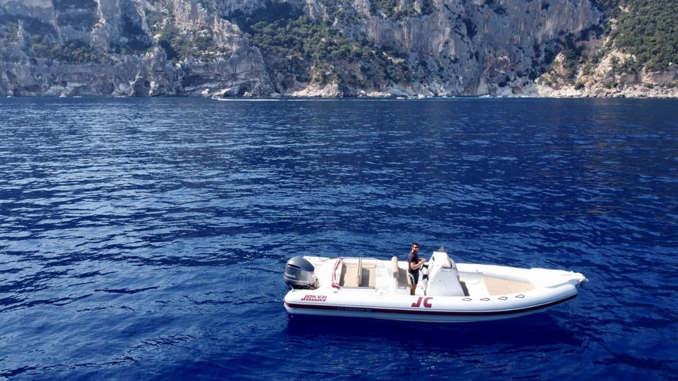 Joker Boat 26 Clubman | Exclusive boat tour from Cala Gonone along the Gulf of Orosei and Baunei Coast, exploring hidden coves, caves, and crystal-clear waters.