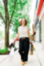 A woman outside carrying shopping bags