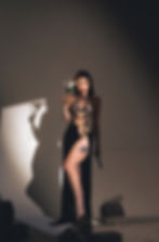 A woman in a black dress holding a white flower