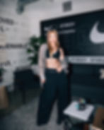 A woman modeling with Nike symbols in the background