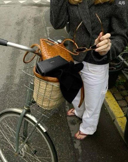 Girls on a bike in white jeans and flip flops