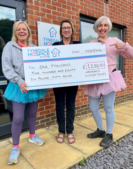 Three women holding a check for £1,286.50 at Tynedale Hospice, dated 09/09/2026.