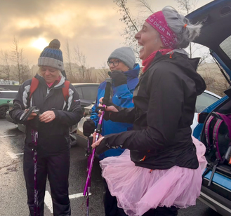 Three women laughing, wearing winter attire, preparing for Hadrian's Hike for Tynedale Hospice charity walk.