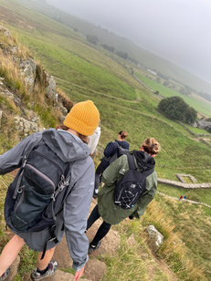 Three hikers on a hillside walk; Hadrian's Hike for Tynedale Hospice; charity walk on Hadrian's Wall.