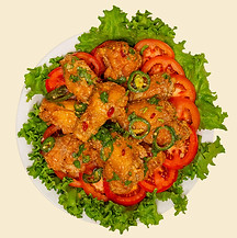 a photo of glazed fish sauce chicken wings with tomatoes and lettuce