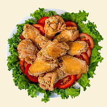 a photo of original flavor chicken wings on a plate with tomatoes and lettuce