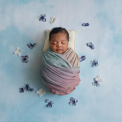 rainbow baby girl in wrapped pose