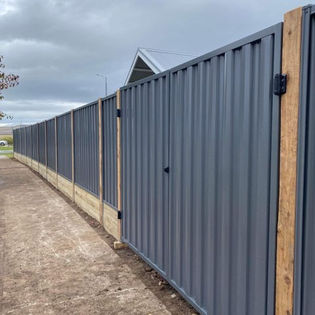 Colorbond fencing with exposed cypress posts and double sleepers