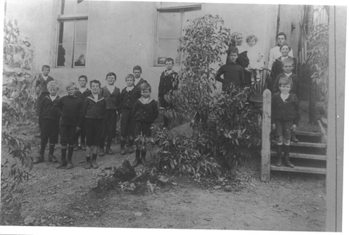 Parkerville Children's home with a nun holding a baby in the background.