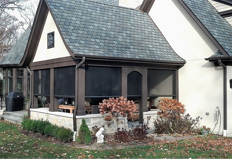 Seamless protection with Magnatrack hurricane screens on a home, showing windows and doors shielded from hurricane-force winds and flying debris.