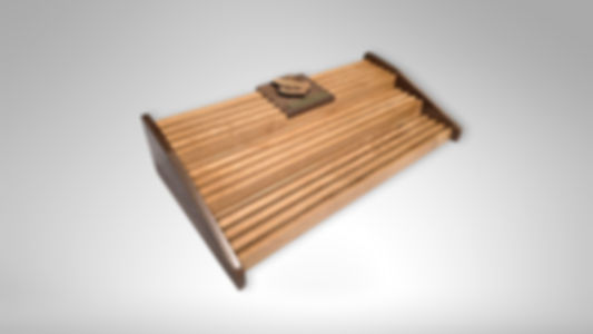 Handmade wooden coin holder showing three tiers and natural alder and walnut wood grain.
