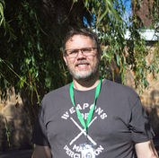 A smiling man under a tree